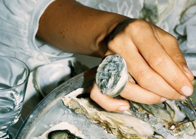 Hand with oyster ring choosing food